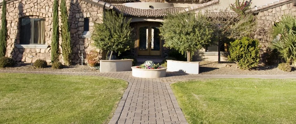 Mowed grass and neat shrubs along some walkways in Hurst, TX.