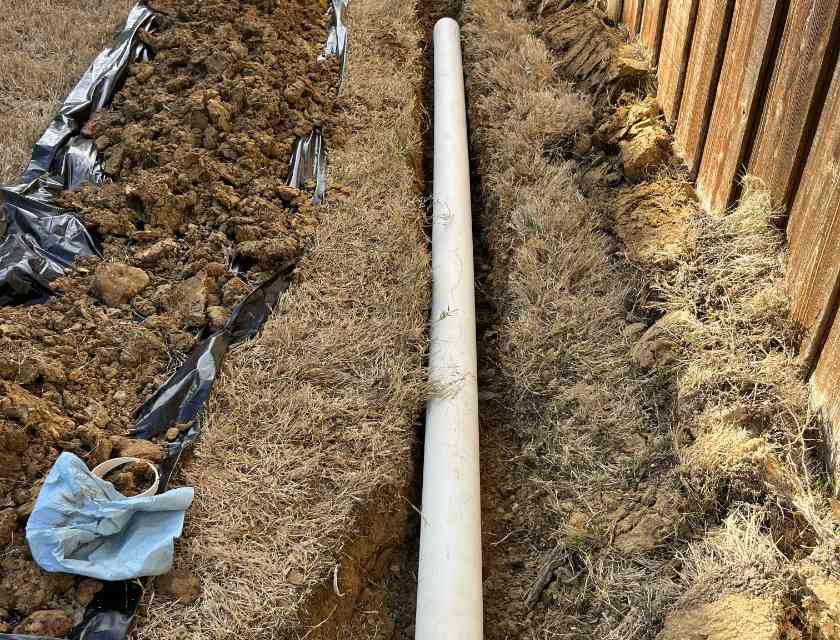 Drain installation by Lawn & Landcare, showcasing French drain installation to improve yard drainage.